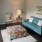 a living room with a blue couch and a lamp