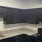 a kitchen with black cabinets